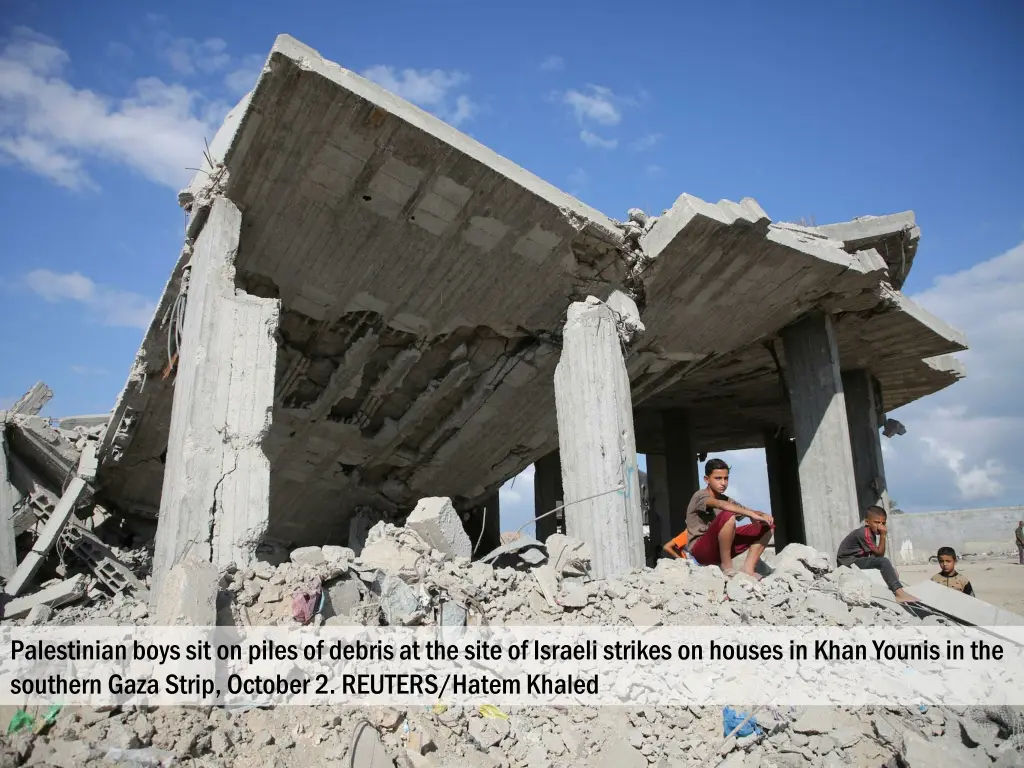 palestinian boys sit on piles of debris