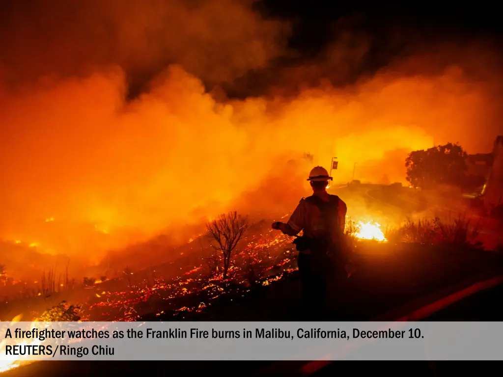 a firefighter watches as the franklin fire burns 1