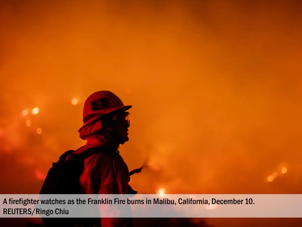 a firefighter watches as the franklin fire burns