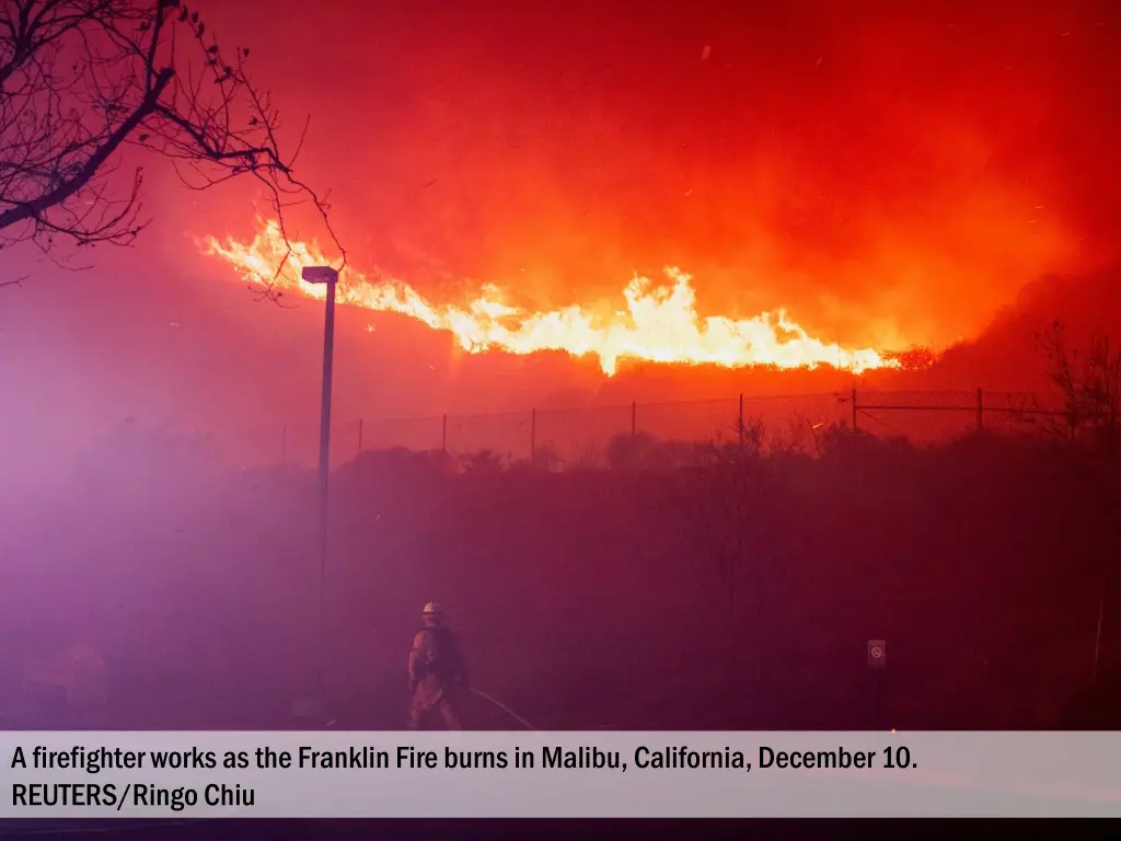 a firefighter works as the franklin fire burns