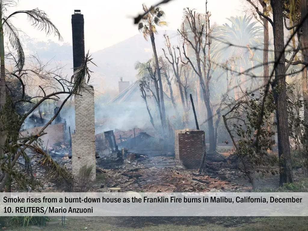 smoke rises from a burnt down house