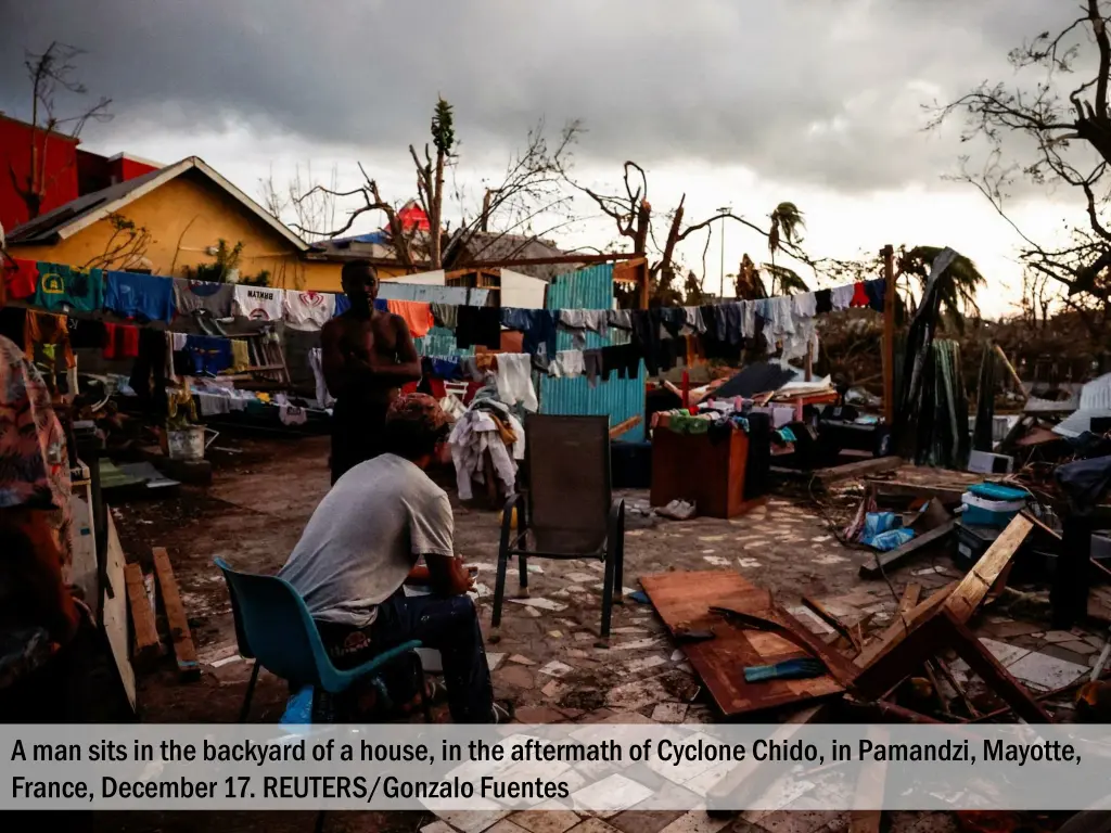 a man sits in the backyard of a house