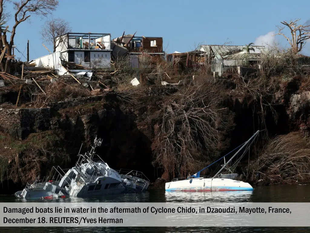 damaged boats lie in water in the aftermath