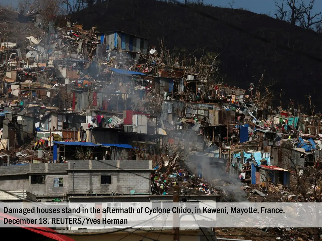 damaged houses stand in the aftermath of cyclone 1