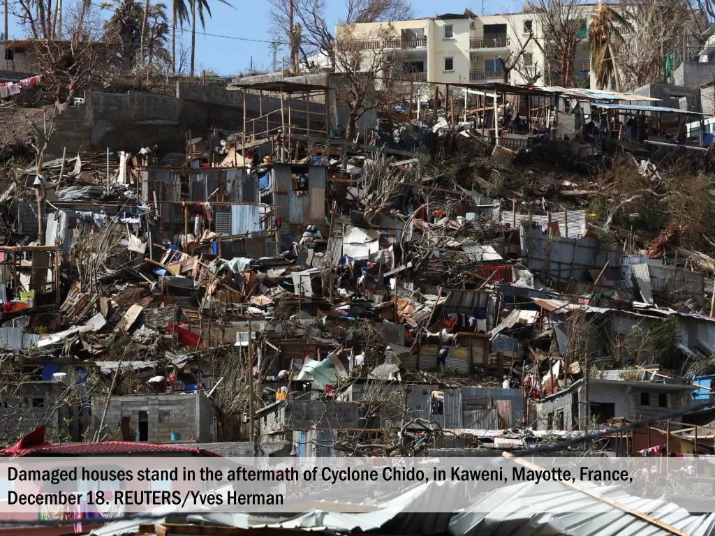 damaged houses stand in the aftermath of cyclone