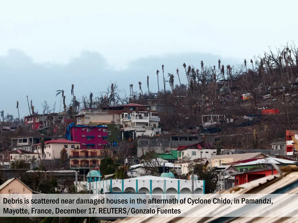 debris is scattered near damaged houses