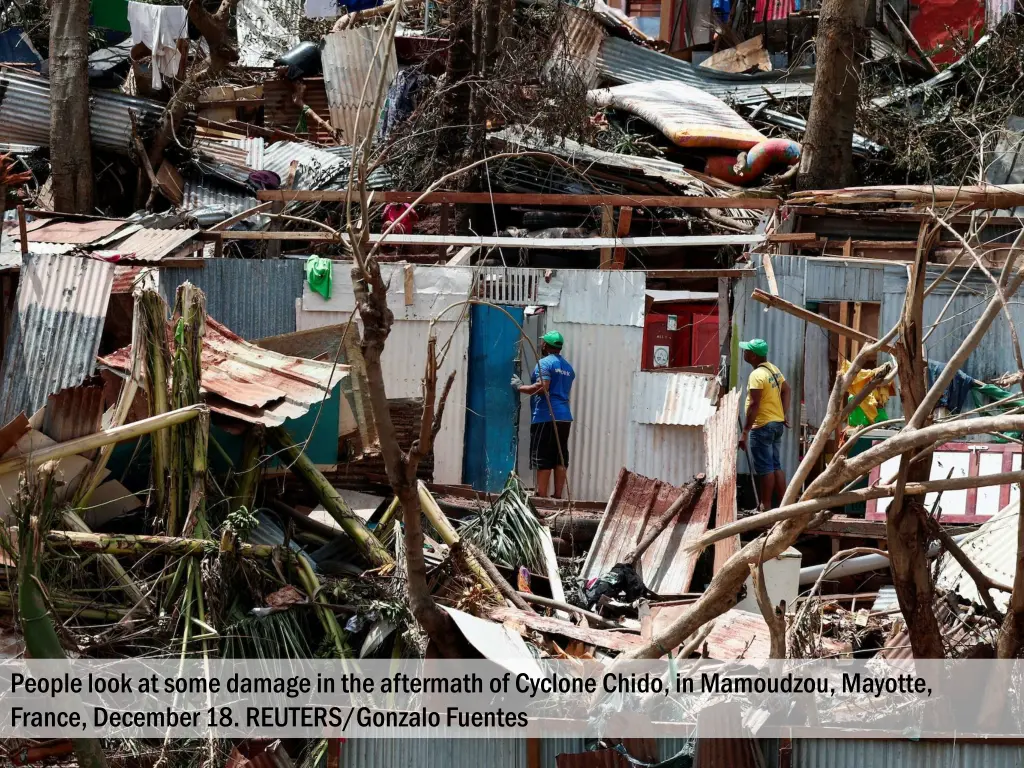 people look at some damage in the aftermath