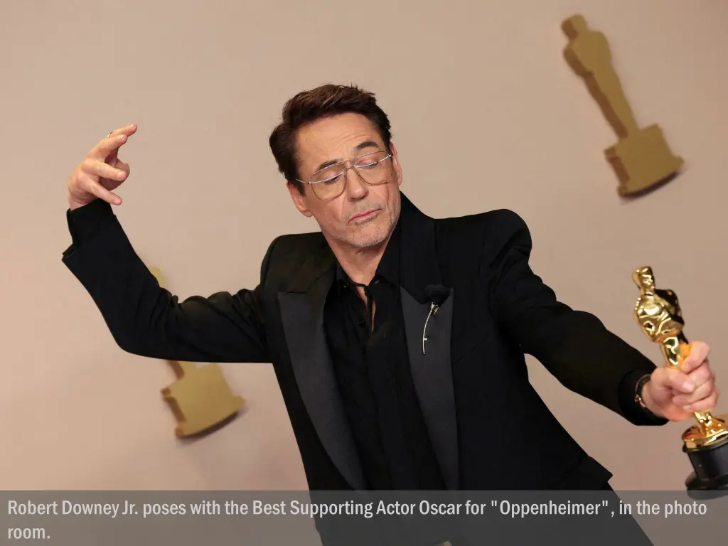 robert downey jr poses with the best supporting