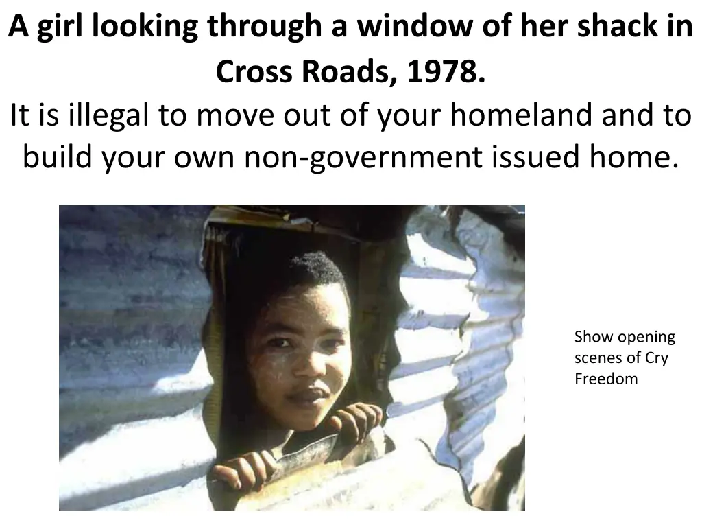 a girl looking through a window of her shack