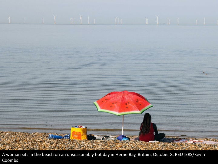 a woman sits in the beach on an unseasonably