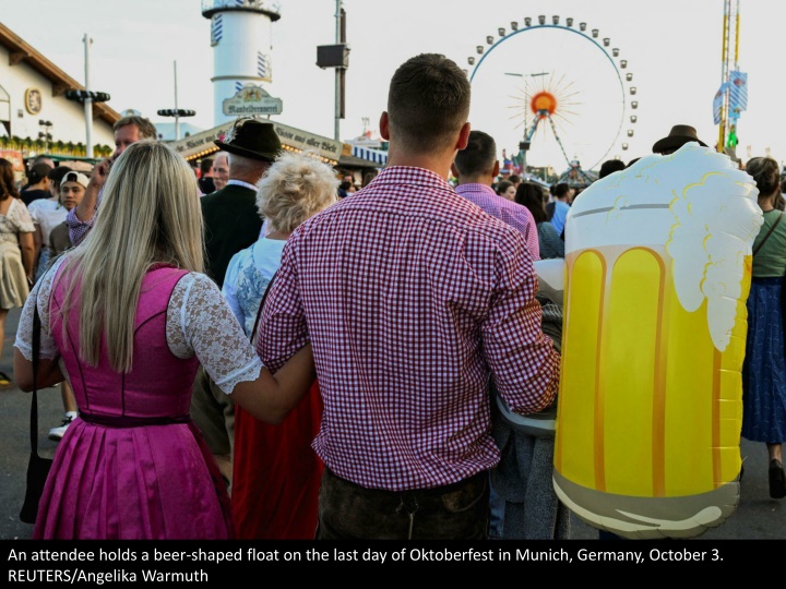 an attendee holds a beer shaped float on the last