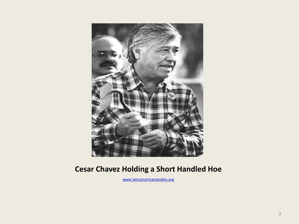cesar chavez holding a short handled hoe
