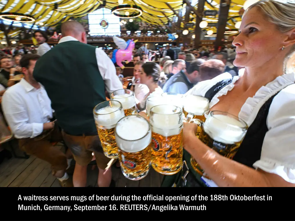 a waitress serves mugs of beer during