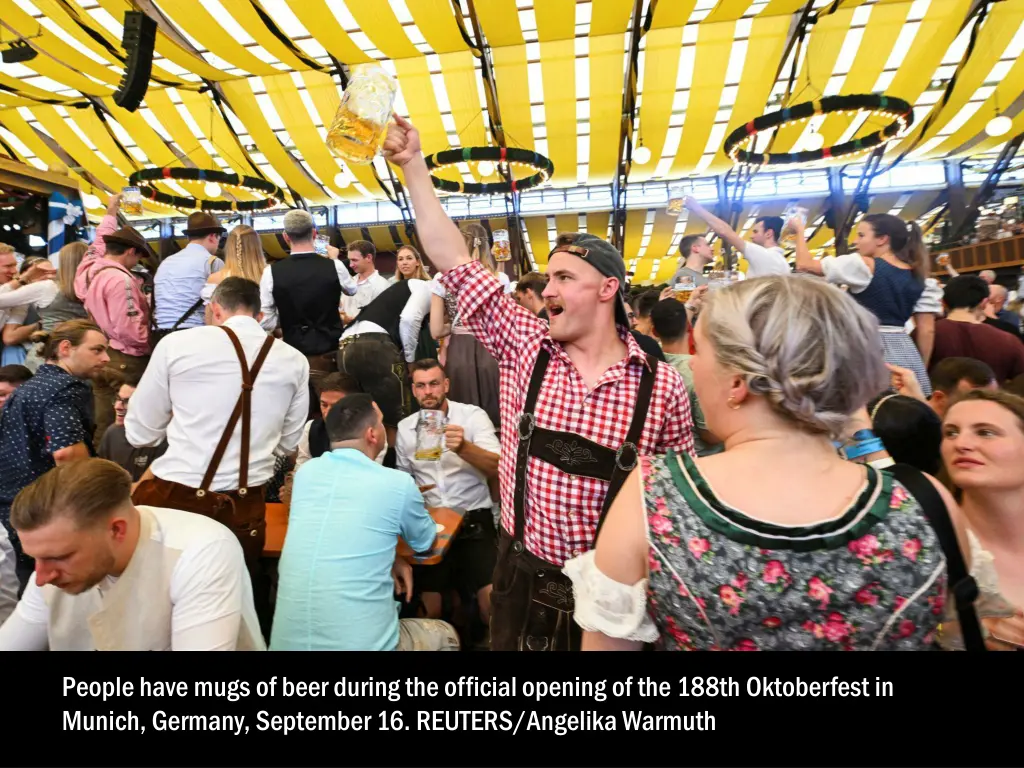 people have mugs of beer during the official 1