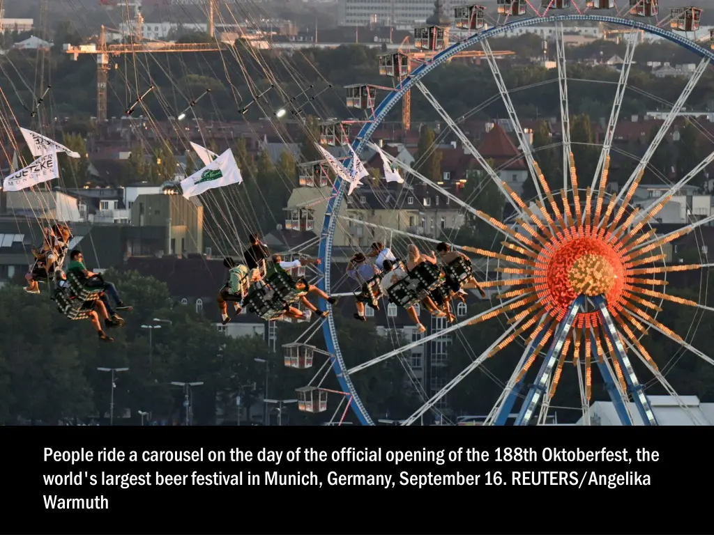 people ride a carousel on the day of the official