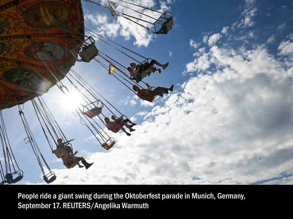 people ride a giant swing during the oktoberfest