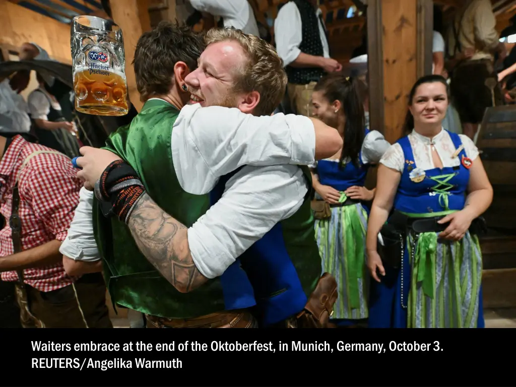 waiters embrace at the end of the oktoberfest