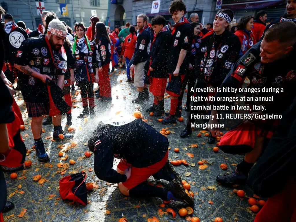 a reveller is hit by oranges during a fight with