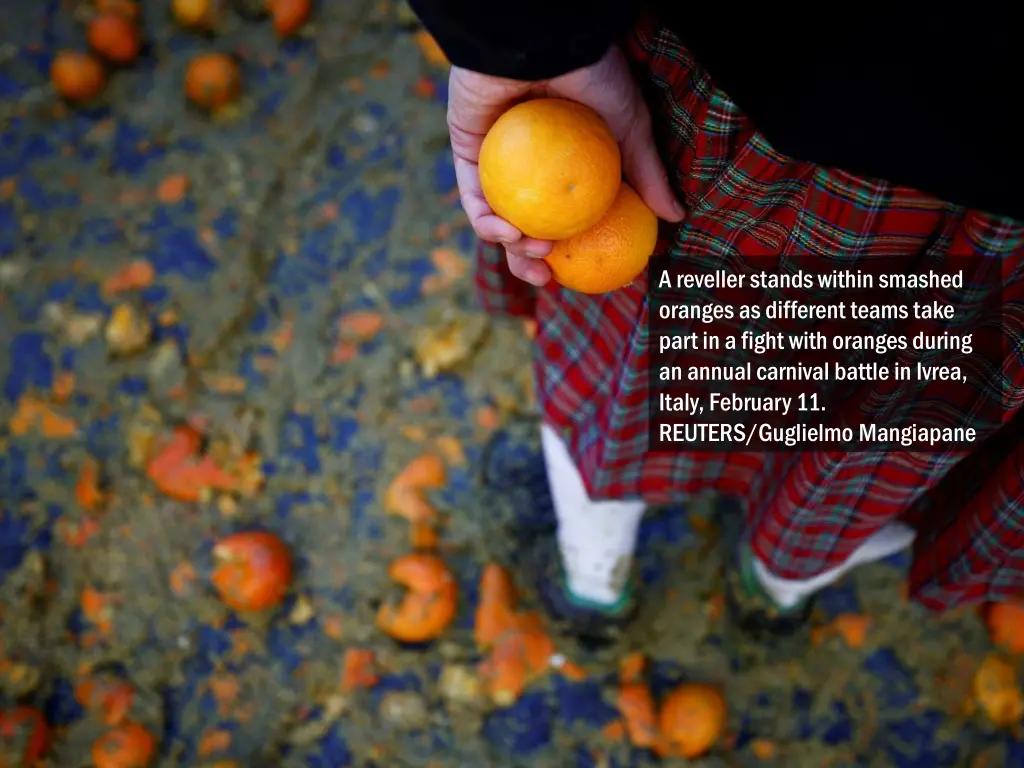 a reveller stands within smashed oranges 2