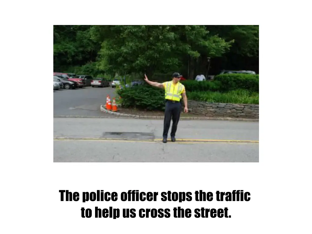 the police officer stops the traffic to help