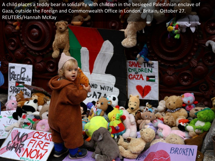 a child places a teddy bear in solidarity with
