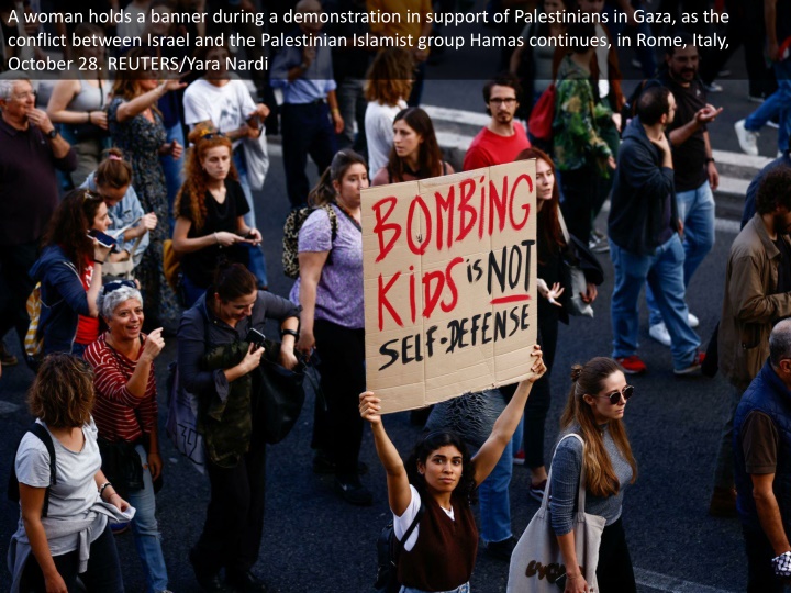 a woman holds a banner during a demonstration