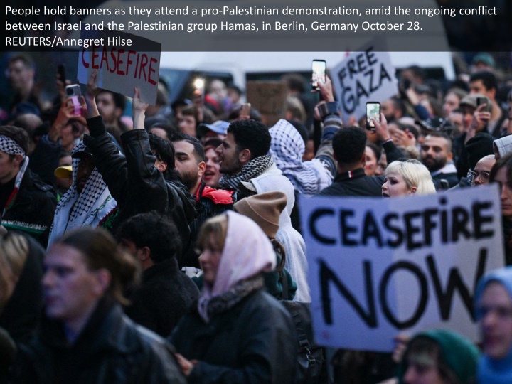 people hold banners as they attend 1