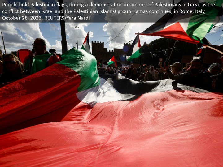 people hold palestinian flags during