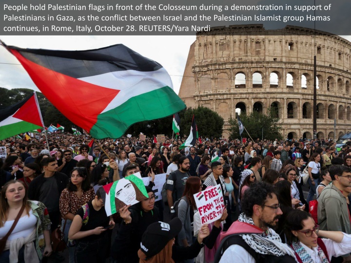 people hold palestinian flags in front