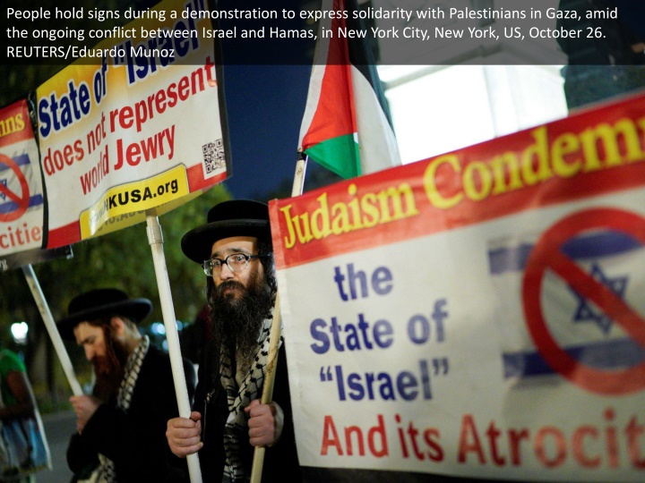 people hold signs during a demonstration