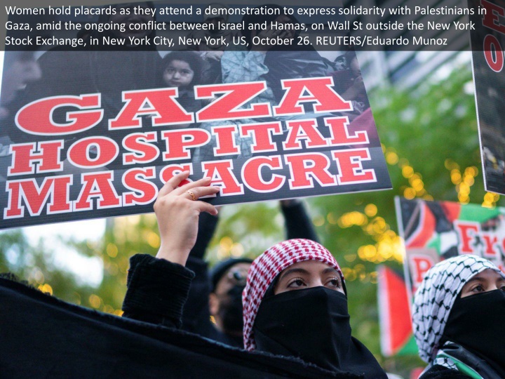 women hold placards as they attend